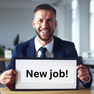 A smiling guy with a sign that reads "new job" in his hands.
